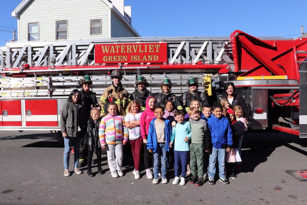 Students crowd around firefighters, 