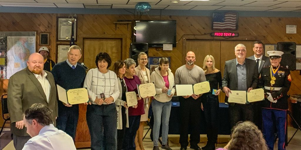 Group of people stand with Superintendent after receiving honorary diplomas