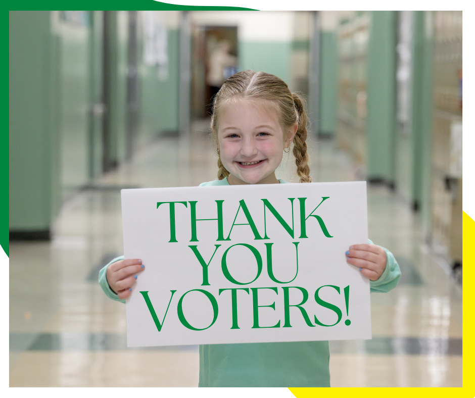 Small blonde child holding sign that says "thank you voters"