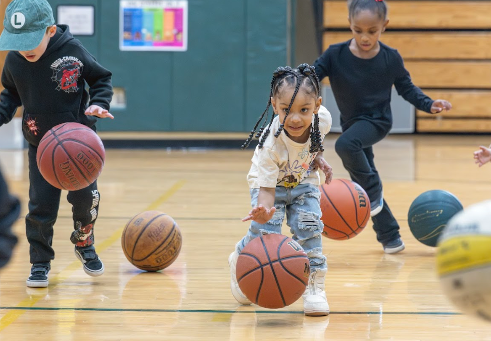 Children play with basketballs in Healty's Gym